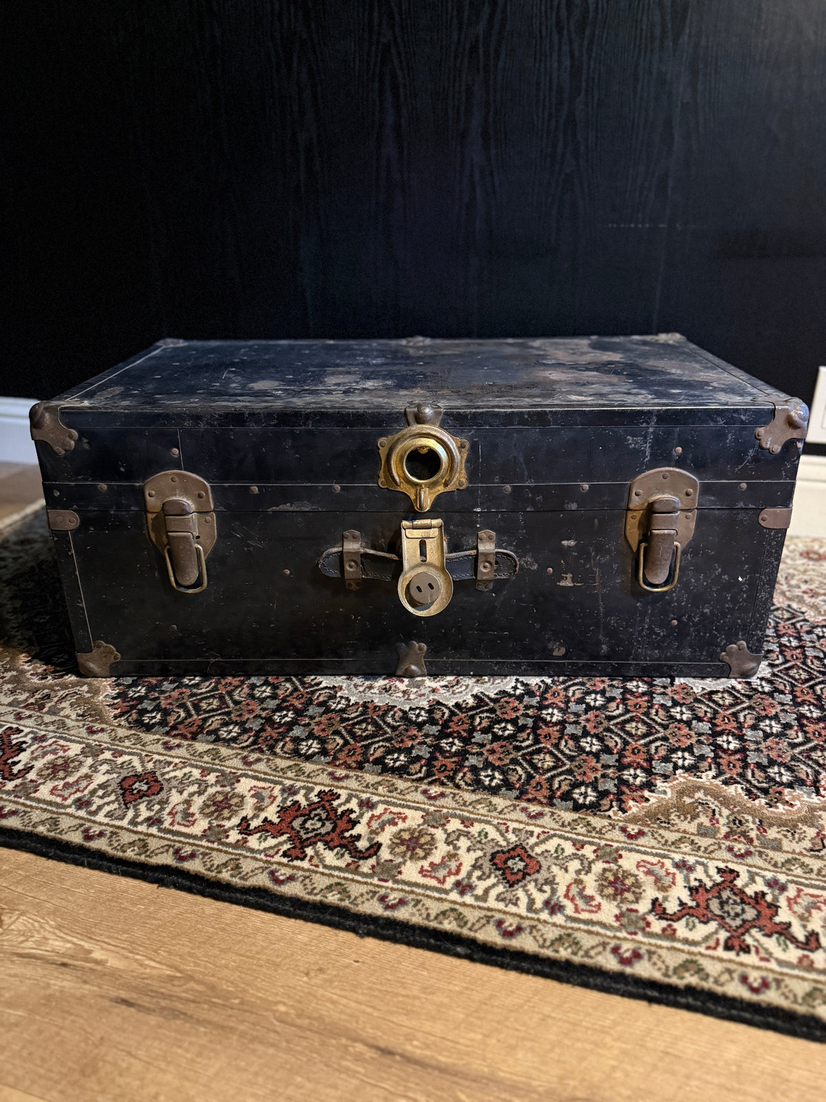 c. 1920 black japanned steel steamer trunk with brass trim, styled at home