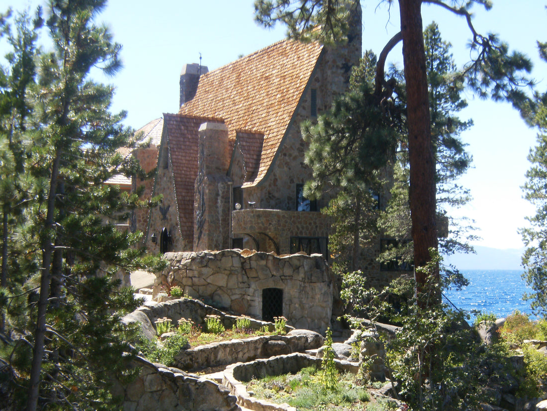 The Thunderbird Lodge on the Nevada shore of Lake Tahoe, mostly hidden by tall evergreens above the water. U.S. National Archives photograph by Ronda Kingsford, 2009; public domain.