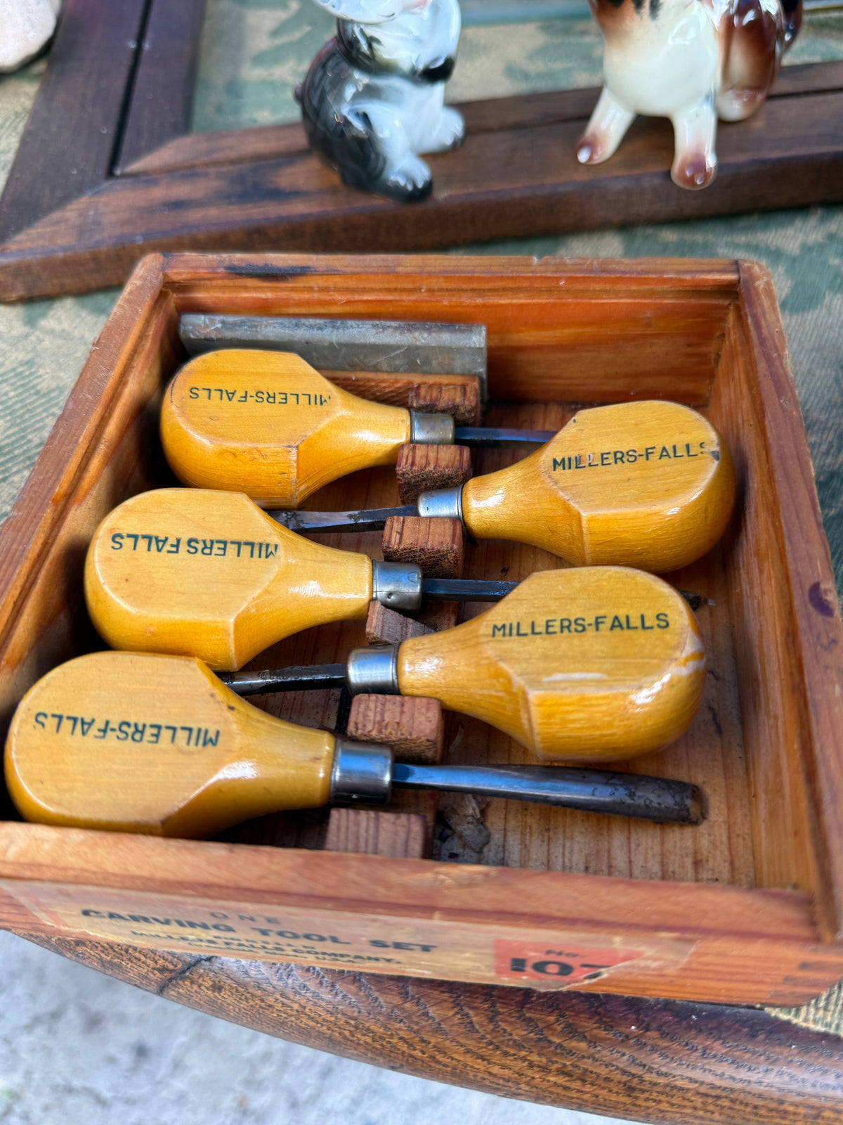 Antique carving tool set — palm-handle gouges, chisels, U-tool and V-tool with oilstone