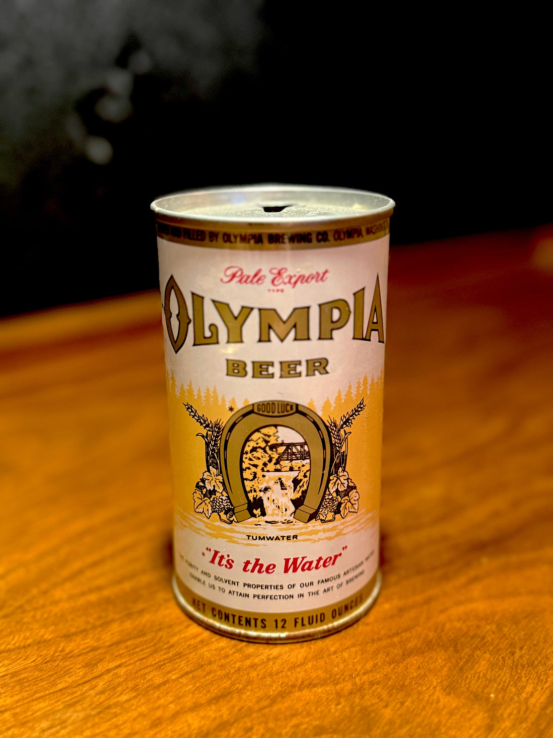 Vintage 1950s lithographed steel Olympia beer can, a period tavern object.