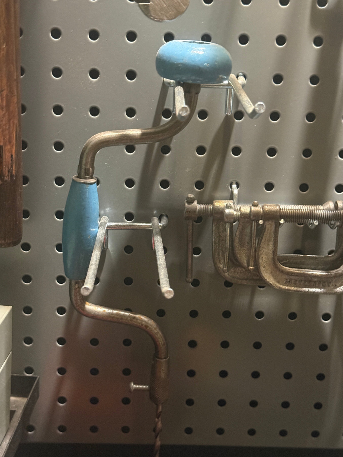 Vintage American ratcheting bit brace with blue-painted head and grip, nickel frame, and auger bit installed, c. 1940-1965