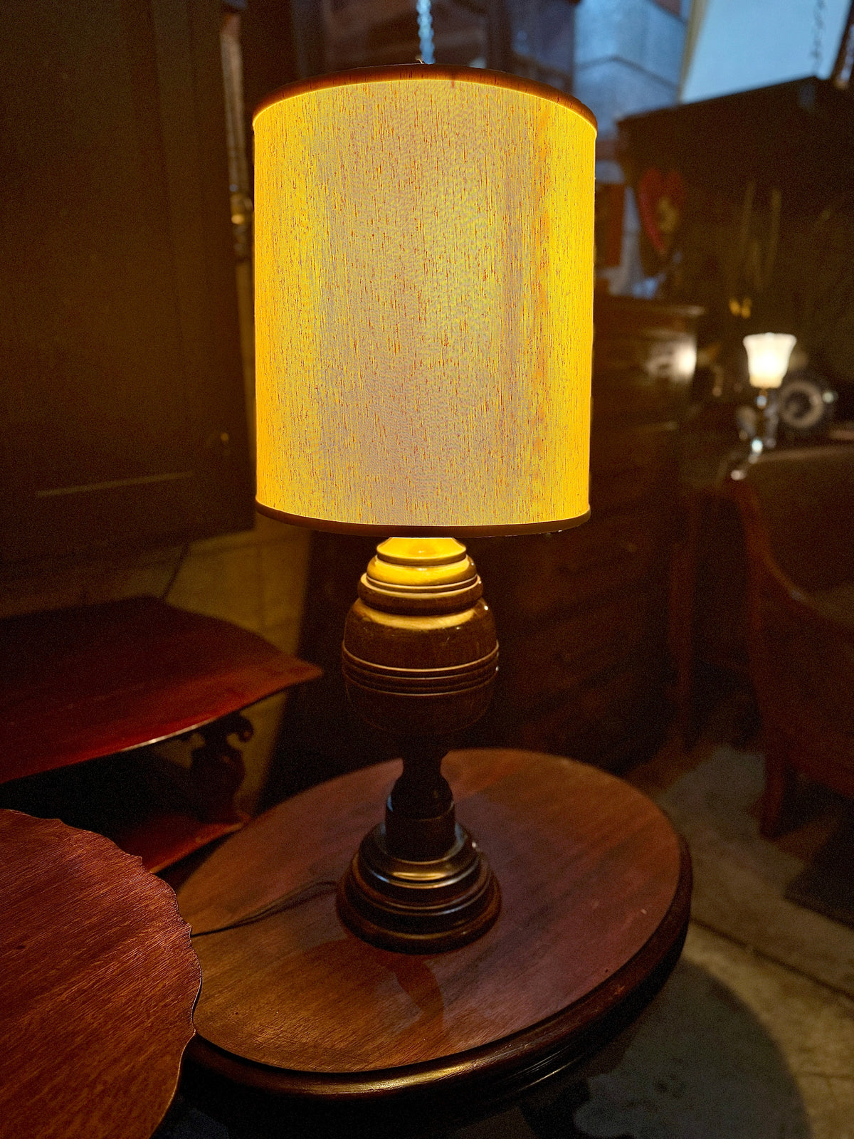 Vintage turned-wood table lamp with brass collar and parchment shade, 1940s–50s
