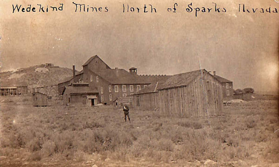 The Wedekind mines near Sparks, Nevada, circa 1900–1903: the mill and mine buildings with a lone figure standing in the sagebrush before them