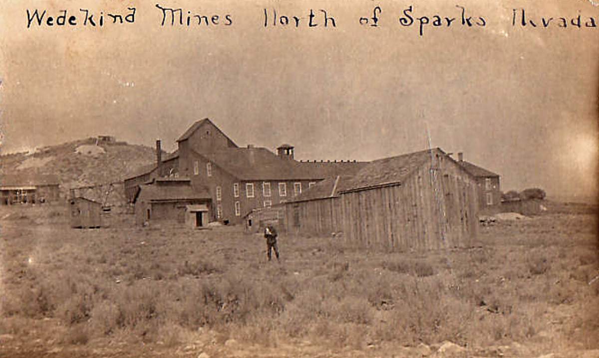 The Wedekind mines near Sparks, Nevada, circa 1900–1903: the mill and mine buildings with a lone figure standing in the sagebrush before them
