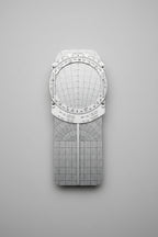 Silver protractor with grid on a yellow woven surface