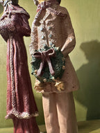 Three Hand-Painted Victorian Caroler Figures, Elongated Folk-Art Modelling with Dry-Brushed Antique Finish, Muffs, Bonnets and a Bell-Hung Wreath, Sold as a Set, c. 1985–2000