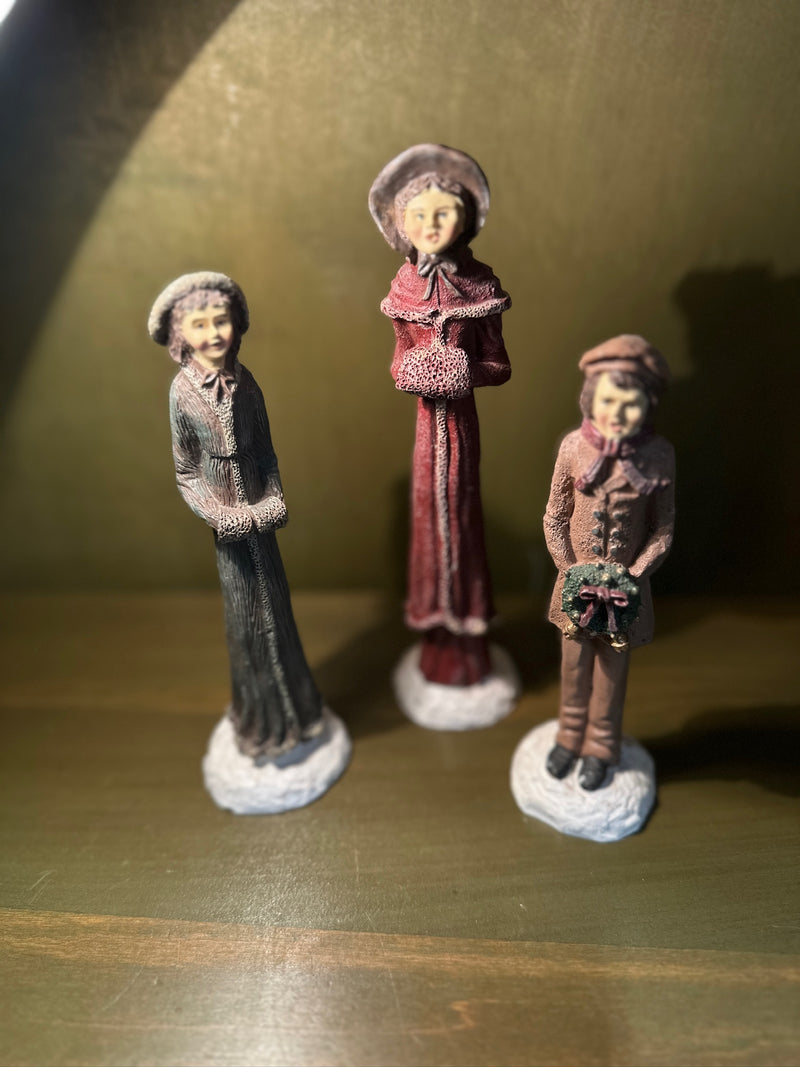 Three Hand-Painted Victorian Caroler Figures, Elongated Folk-Art Modelling with Dry-Brushed Antique Finish, Muffs, Bonnets and a Bell-Hung Wreath, Sold as a Set, c. 1985–2000
