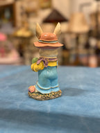 Cold-Painted and Hand-Gilded Easter Rabbit Figure in a Pink Brimmed Hat and Blue Overalls, Standing on a Flowered Base with Eggs, Early to Mid 20th Century