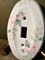 Porcelain Single-Toggle Switch Plate with Pink Dogwood Transfer Decoration, Oval Form, Unused with the Original Screws Still Sealed to the Reverse