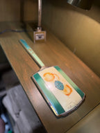 Art Deco Gilt-Metal Hand Mirror, Graduated Green and Cream Enamelled Back with Gold Pinstriping, Stepped Fan Palmette and Reeded Handle, Bevelled Plate, c. 1925–1940