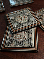 Set of Six Damascene Marquetry and Mother-of-Pearl Coasters with Fitted Caddy, Syria, c. 1940–1970