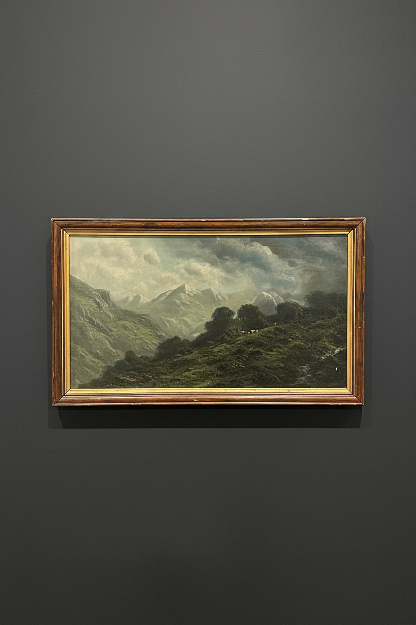 Framed painting of a mountain landscape on a gray floor.