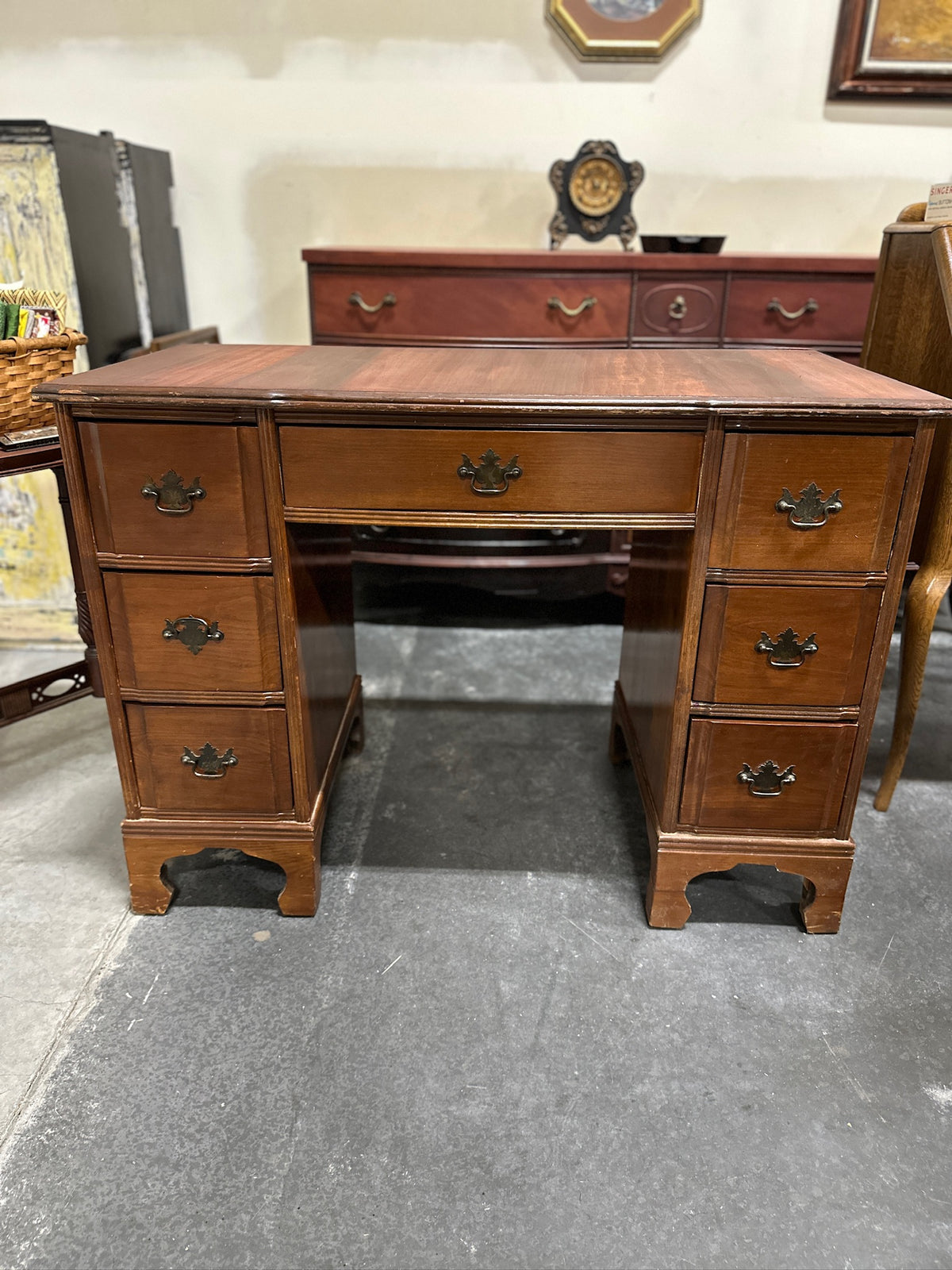 Colonial Revival Kneehole Desk, Seven Drawers with Batwing Brasses and Bracket Feet, Refinished by Walter Hinchman in Sedona Red, Antique Walnut and Mahogany, c. 1940–1955