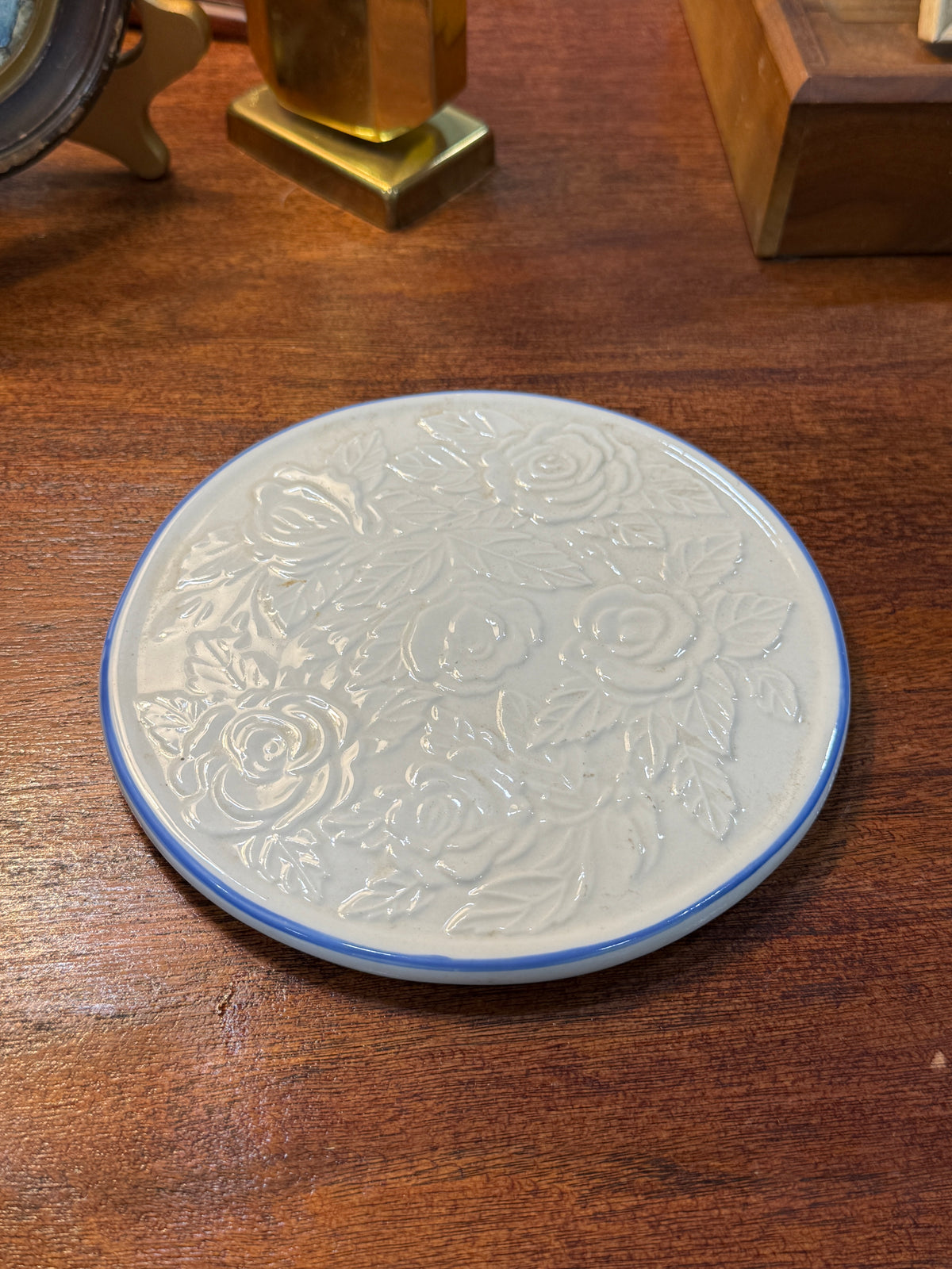 Embossed Rose Ceramic Trivet, Cream Glaze with Cobalt Banded Rim, c. 1940–1970