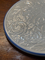 Embossed Rose Ceramic Trivet, Cream Glaze with Cobalt Banded Rim, c. 1940–1970