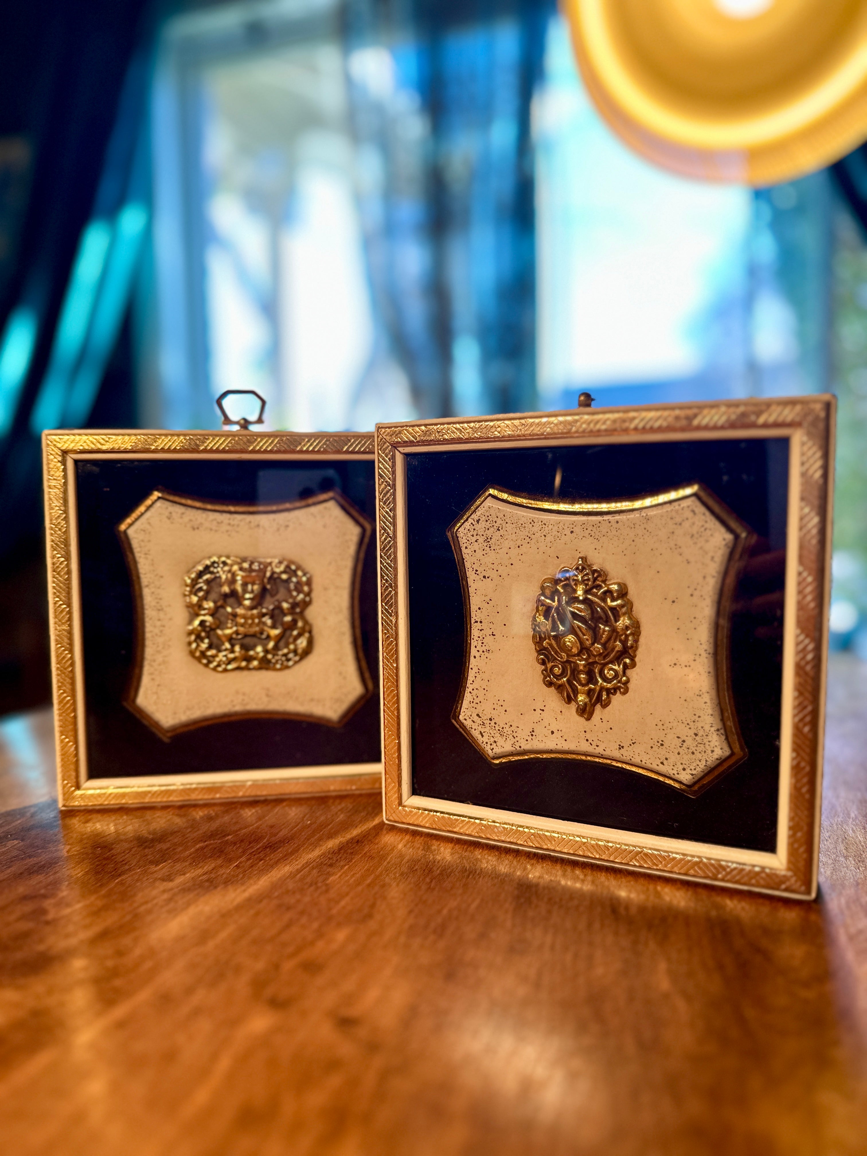 Pair of vintage Florentine-style gold relief wall plaques with heraldic motifs in gilt frames. Mid-century Italian decorative wall art, circa 1960s.