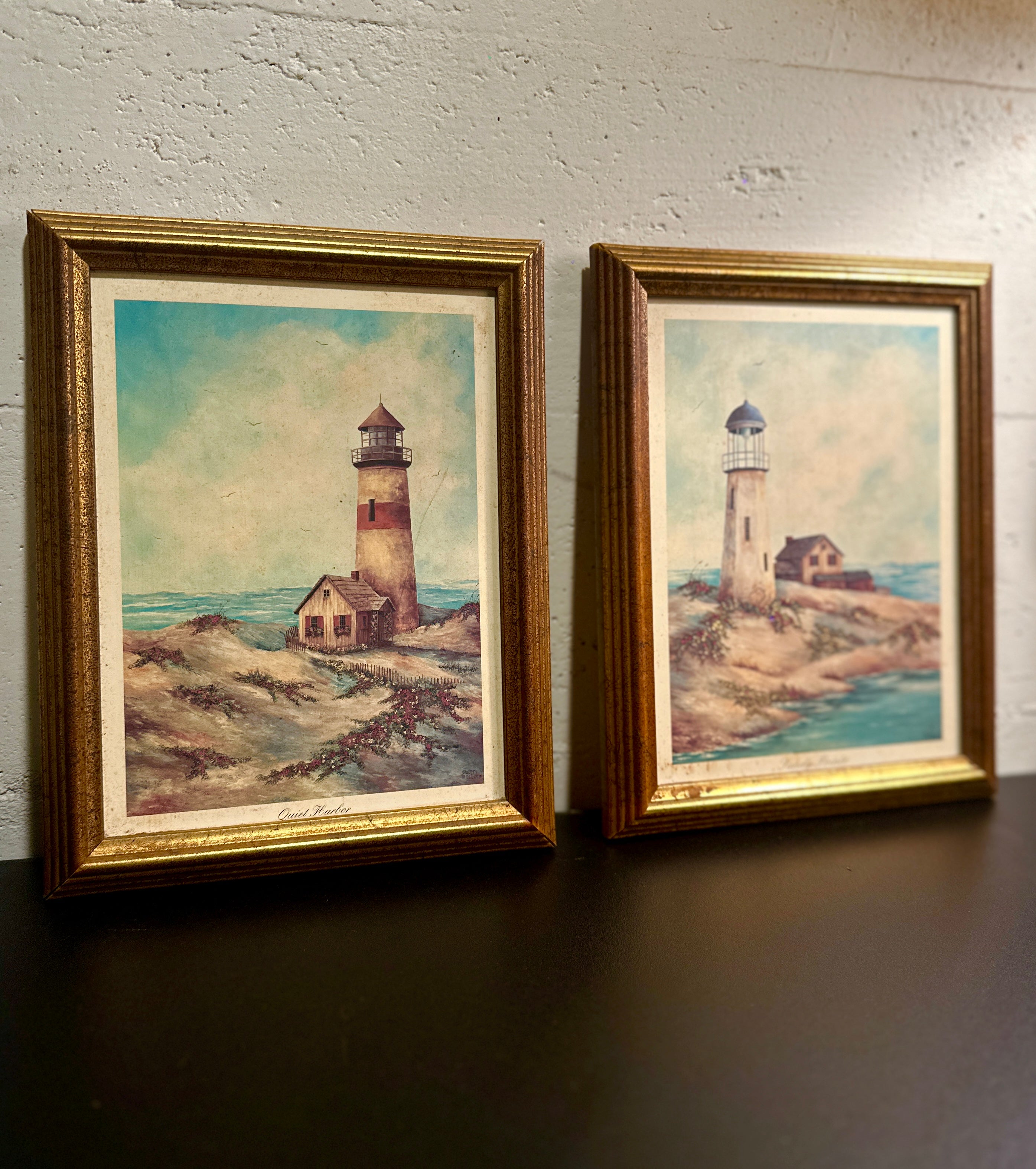 Quiet Harbor & Sandy Pointe Pair of vintage framed lighthouse prints titled Quiet Harbor and Sandy Pointe. Matching coastal artwork set with gilt wood frames, sold together.| Vintage Framed Lighthouse Print Set