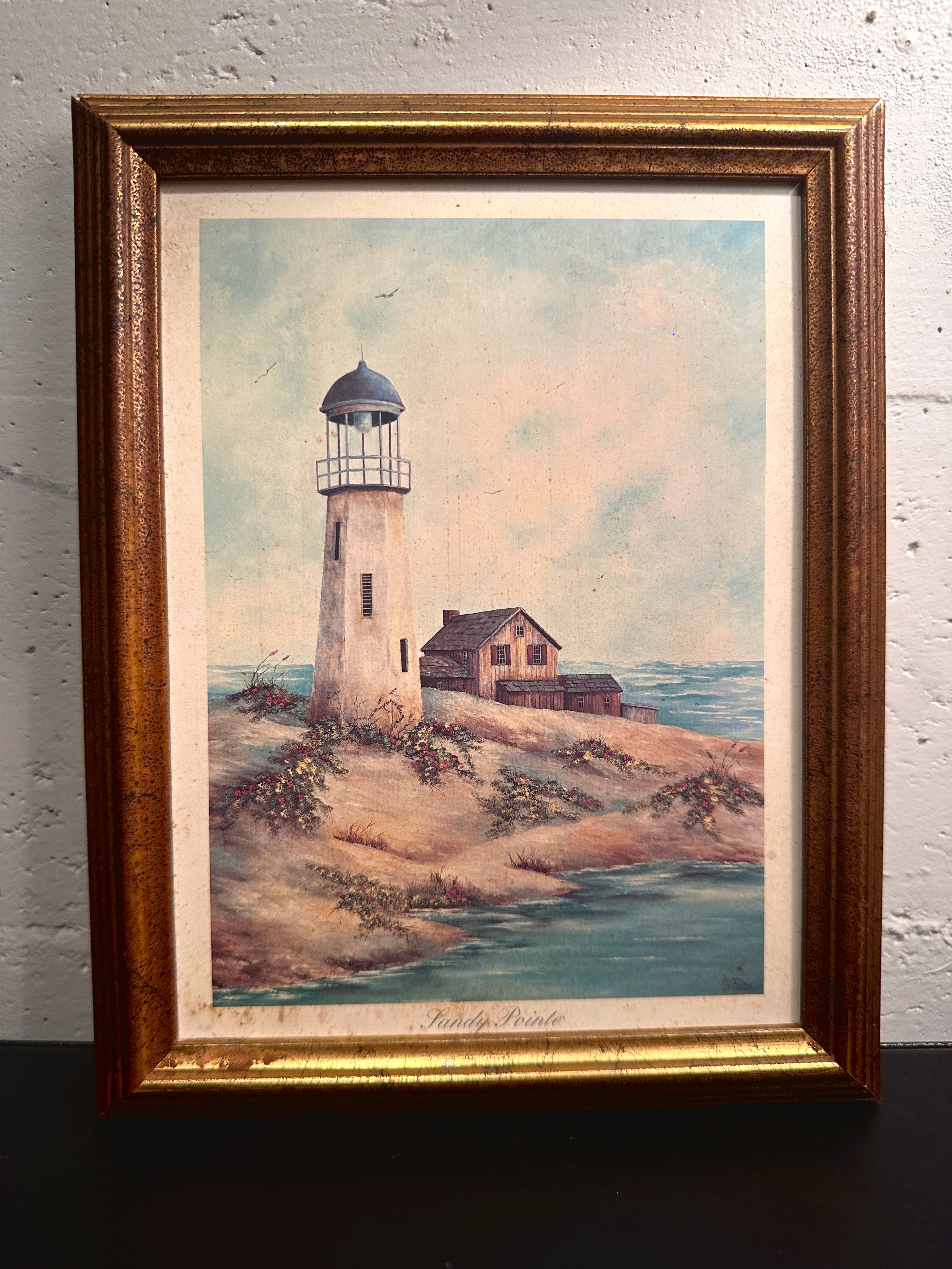 Quiet Harbor & Sandy Pointe Pair of vintage framed lighthouse prints titled Quiet Harbor and Sandy Pointe. Matching coastal artwork set with gilt wood frames, sold together.| Vintage Framed Lighthouse Print Set
