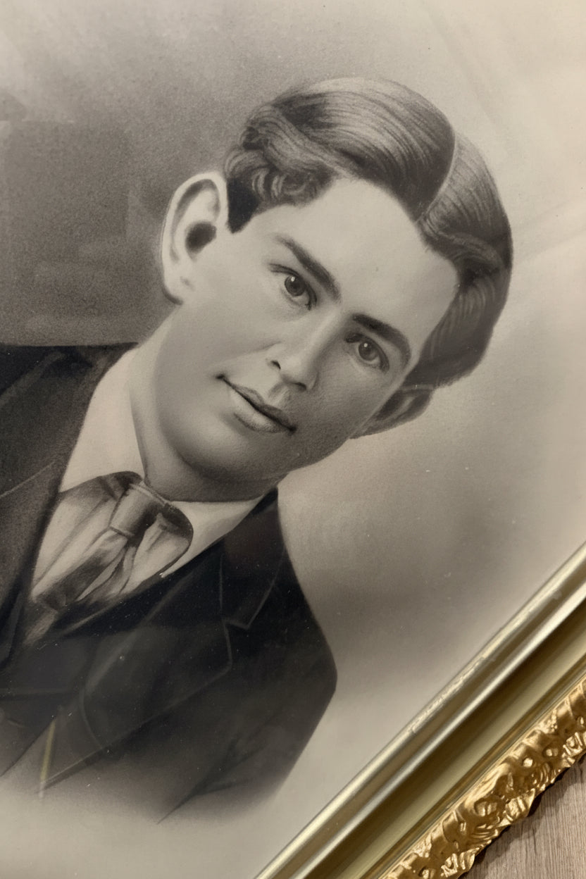 Vintage black and white portrait of a man with a gold frame
